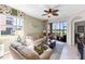 Comfortable living room with neutral tones, decorative curtains, and a view of the screened lanai at 8205 Grand Estuary Trl # 101, Bradenton, FL 34212