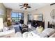 Cozy living room featuring comfortable sofas, stylish decor, and a view of the screened lanai at 8205 Grand Estuary Trl # 101, Bradenton, FL 34212