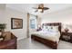 Tranquil bedroom with a wooden bed frame, soft lighting, and a peaceful view from the window at 8205 Grand Estuary Trl # 101, Bradenton, FL 34212
