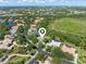 Aerial view of home with mature landscaping, near a golf course and lakes at 8838 Bloomfield Blvd, Sarasota, FL 34238