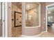 Walk in tiled shower with frameless glass door and stone accents at 8838 Bloomfield Blvd, Sarasota, FL 34238