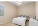 Cozy bedroom featuring a ceiling fan, neutral walls, and natural light from the window at 8838 Bloomfield Blvd, Sarasota, FL 34238
