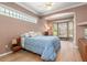Cozy bedroom features a large window, neutral walls, and hardwood floors at 8838 Bloomfield Blvd, Sarasota, FL 34238