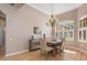 Dining room featuring wood floors, chandelier, and natural light at 8838 Bloomfield Blvd, Sarasota, FL 34238