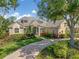 Charming home featuring manicured landscaping and a welcoming brick driveway at 8838 Bloomfield Blvd, Sarasota, FL 34238
