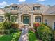Stunning home entrance with stone accents and lush landscaping at 8838 Bloomfield Blvd, Sarasota, FL 34238