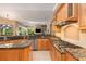 Spacious kitchen with granite counters, stainless steel appliances, and abundant wood cabinet storage at 8838 Bloomfield Blvd, Sarasota, FL 34238