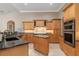 Kitchen features granite countertops, wood cabinets, tile flooring, and stainless steel appliances at 8838 Bloomfield Blvd, Sarasota, FL 34238