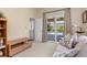 Cozy living room view with a sliding glass door leading to a screened pool area at 8838 Bloomfield Blvd, Sarasota, FL 34238