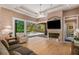 Cozy living room featuring a fireplace and backyard pool view at 8838 Bloomfield Blvd, Sarasota, FL 34238