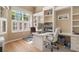 Bright office with custom built-in shelving, large window, and sleek wood floors at 8838 Bloomfield Blvd, Sarasota, FL 34238