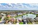 Aerial view of lakeside homes with manicured lawns and lush green landscaping, offering serene waterfront living at 8995 Founders Cir, Palmetto, FL 34221