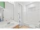 Bright bathroom featuring a single sink vanity, combined tub and shower, and tile flooring at 8995 Founders Cir, Palmetto, FL 34221