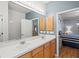 Spacious bathroom with a double sink vanity, white countertops, and views to the bedroom at 8995 Founders Cir, Palmetto, FL 34221