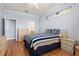 Bedroom with hardwood floors, blue striped bedding, two closets and doorway leading to a bathroom at 8995 Founders Cir, Palmetto, FL 34221
