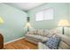 Bonus room features a comfy sofa, accent pillows, a side table and a nice window at 8995 Founders Cir, Palmetto, FL 34221