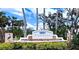 Fairways at Imperial Lakewoods neighborhood sign in front of lush landscaping and palm trees at 8995 Founders Cir, Palmetto, FL 34221