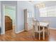 Dining room with a table set for four, cabinet and wood floors at 8995 Founders Cir, Palmetto, FL 34221