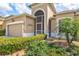 Inviting home featuring a lush green lawn and well-maintained landscaping at 8995 Founders Cir, Palmetto, FL 34221