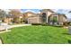 Beautiful home with lush green lawn and well-maintained landscaping at 8995 Founders Cir, Palmetto, FL 34221