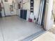View of the garage with painted floor, overhead storage, and access to house at 8995 Founders Cir, Palmetto, FL 34221
