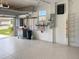 View of the garage with painted floor, storage racks, tool rack, and work bench at 8995 Founders Cir, Palmetto, FL 34221