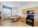 Updated kitchen with light wood cabinets, modern appliances, and a cozy dining nook at 8995 Founders Cir, Palmetto, FL 34221