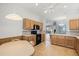 Updated kitchen with wood cabinets, modern appliances, and view of the living room at 8995 Founders Cir, Palmetto, FL 34221