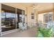 Enjoy this covered patio with comfortable seating, a ceiling fan, and easy access through a large sliding glass door at 8995 Founders Cir, Palmetto, FL 34221