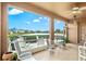 This screened patio offers views of the lake, comfortable seating, and a space perfect for outdoor entertaining at 8995 Founders Cir, Palmetto, FL 34221
