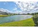 Expansive pond view, showcasing lush green lawns and surrounding homes in the community at 8995 Founders Cir, Palmetto, FL 34221