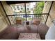 Balcony featuring wrought iron railing and two seats at 105 S Obrien St # 213, Tampa, FL 33609