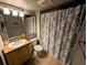 Cozy bathroom featuring a tiled floor, single sink, and toilet beneath a vanity mirror at 105 S Obrien St # 213, Tampa, FL 33609