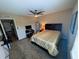 Bedroom featuring a ceiling fan, large bed, television, and an exterior window at 105 S Obrien St # 213, Tampa, FL 33609