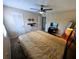 Bedroom features a fan, large bed, tv and mounted hardware on the wall at 105 S Obrien St # 213, Tampa, FL 33609