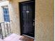 Close-up of the unit's front door with a black finish and welcome mat at 105 S Obrien St # 213, Tampa, FL 33609