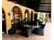 Relaxing outdoor patio area with comfortable seating and shaded covering in a well-maintained community at 105 S Obrien St # 213, Tampa, FL 33609