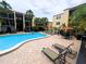 Community pool area with lounge chairs and well-maintained landscaping, perfect for relaxation and recreation at 105 S Obrien St # 213, Tampa, FL 33609
