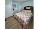 Comfortable bedroom featuring a charming wooden headboard, updated floors and coastal-themed comforter at 112 Park Ter, Venice, FL 34285