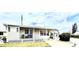 Well-maintained home features a covered porch and tidy landscaping for a welcoming curb appeal at 112 Park Ter, Venice, FL 34285