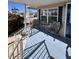 Inviting front porch with cozy seating, featuring a table and two chairs, painted in blue with white railings at 112 Park Ter, Venice, FL 34285