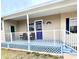 Charming porch with a bright blue painted floor, white railings, and a welcoming entrance at 112 Park Ter, Venice, FL 34285