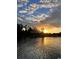 Picturesque sunset view over the tranquil water, with a backdrop of lush trees and a vibrant sky at 112 Park Ter, Venice, FL 34285