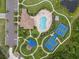 Aerial view of the clubhouse, pool, and tennis courts, nestled among green spaces at 11713 Goldenrod Ave, Bradenton, FL 34212