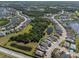 This aerial view showcases the neighborhood's layout, including homes, ponds, roads, and green spaces at 11713 Goldenrod Ave, Bradenton, FL 34212