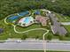 Stunning aerial view of community pool, tennis courts, clubhouse and lush landscaping at 11713 Goldenrod Ave, Bradenton, FL 34212