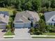 Beautiful aerial view of a well-maintained home with a three-car garage, lush landscaping, and a spacious layout at 11713 Goldenrod Ave, Bradenton, FL 34212