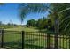 A black fence surrounds the perimeter of the backyard and offers an unobstructed view of the lush green space at 11713 Goldenrod Ave, Bradenton, FL 34212