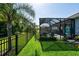 This backyard features a screened pool, privacy fence, lush tropical landscaping, and a well-maintained lawn at 11713 Goldenrod Ave, Bradenton, FL 34212