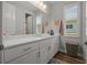 Bathroom boasts a large vanity with dual sinks, framed mirror, and natural light, creating a serene retreat at 11713 Goldenrod Ave, Bradenton, FL 34212